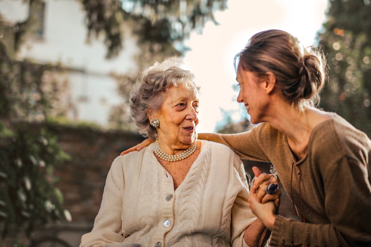 Physiotherapist guiding an elderly patient through gentle exercises