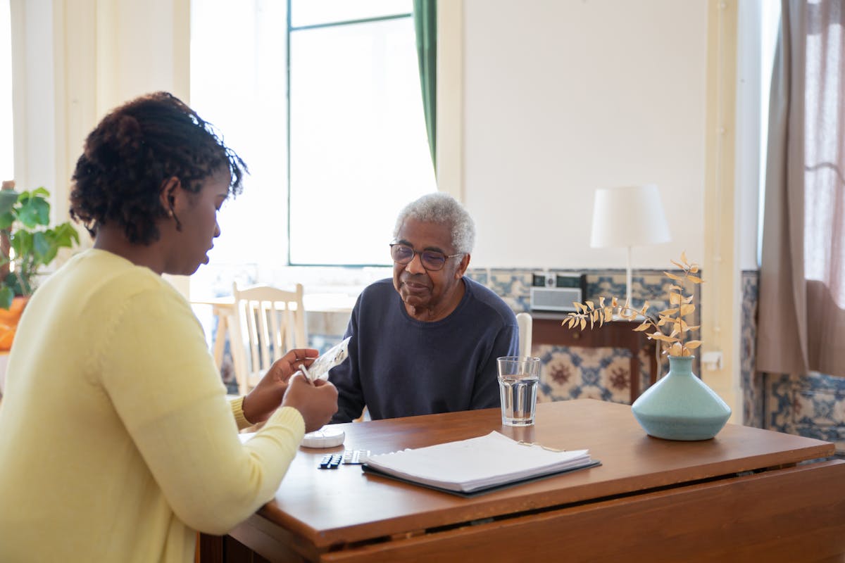 Physiotherapist treating a patient at home